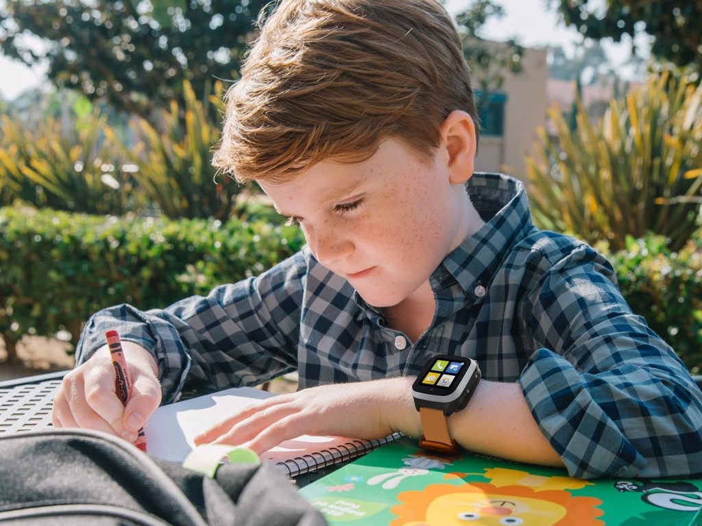 boy wearing Cosmo's JrTrack 2 kids smartwatch spending time outside.